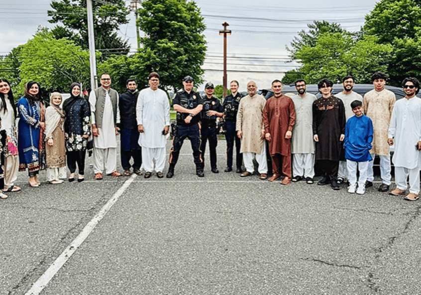 Group in traditional attire with police officers