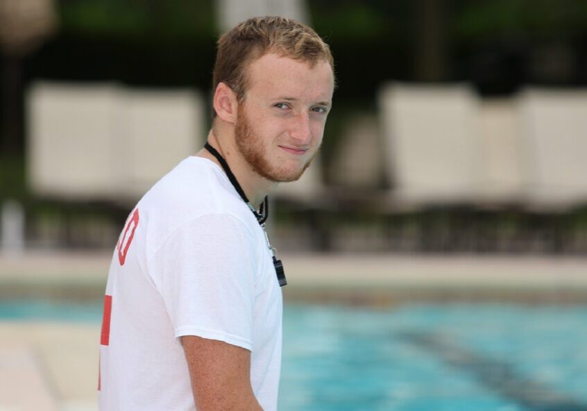 Lifeguard with whistle by pool