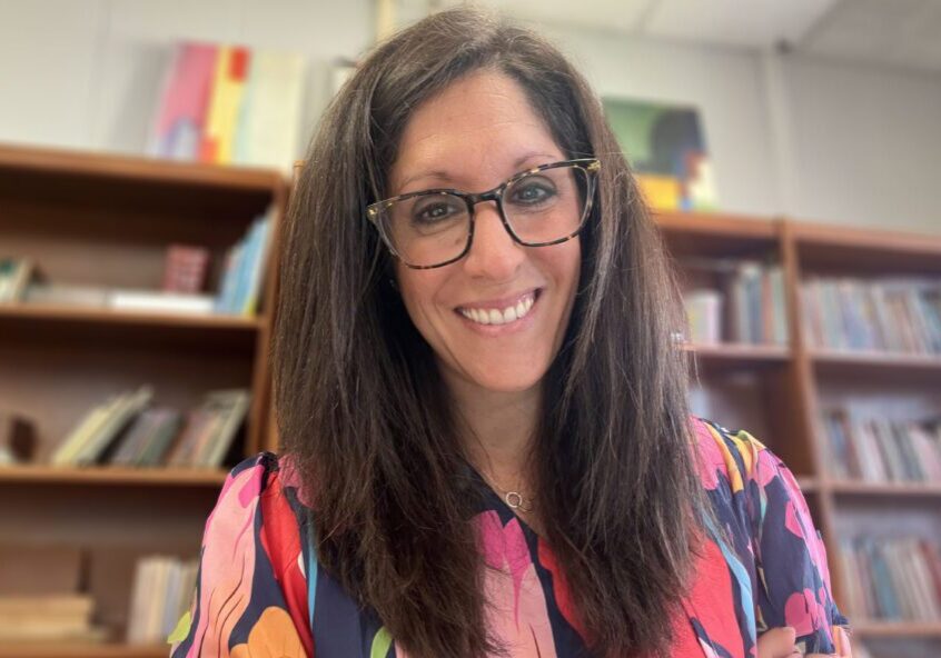 Smiling woman wearing glasses in office