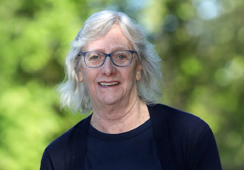 Outdoor portrait of smiling person with glasses
